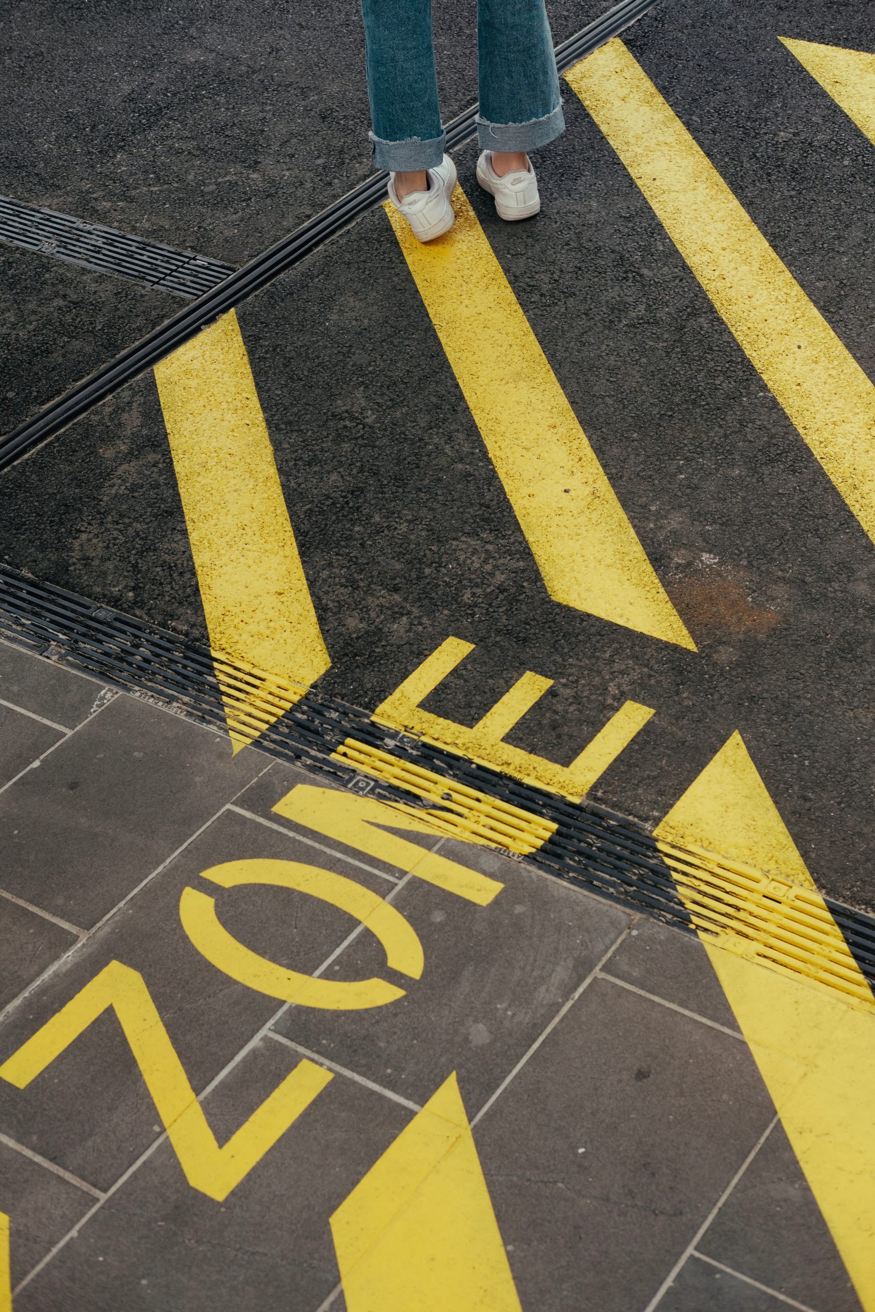 Image of painted lines on the ground, including the word "zone"